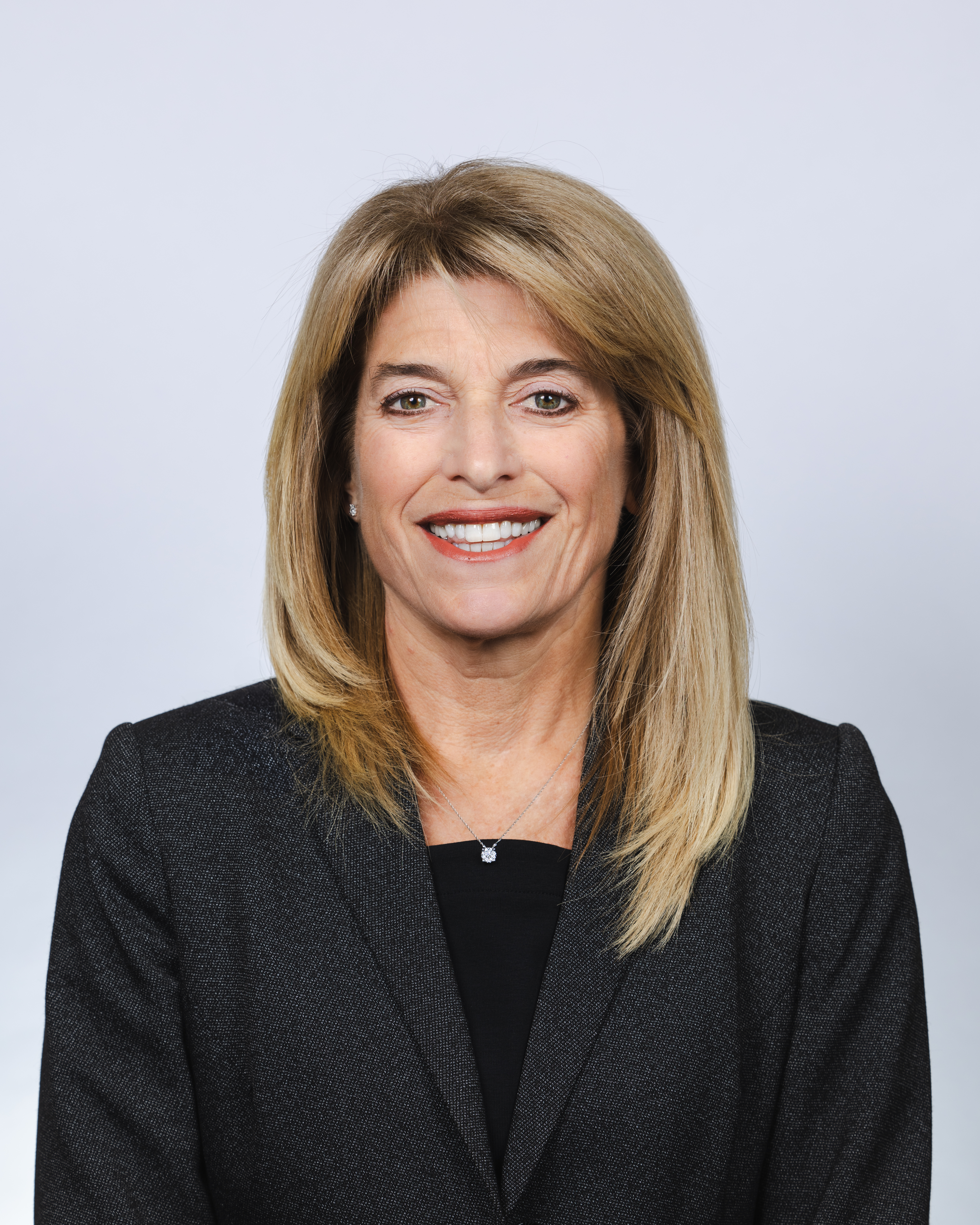 Headshot of woman smiling with light brown hair