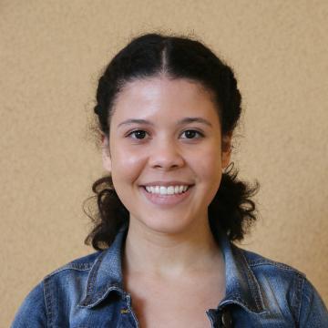 A person smiling against a plain background.