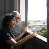 Two people looking out from a high vantage point.