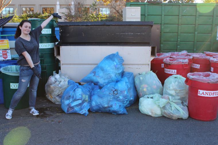 Kayla (waste diversion intern) showcasing a pile of trash at a waste characterization