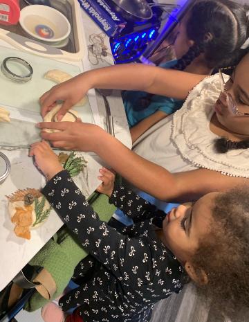 Children creating salt dough ornaments. Winter 2021