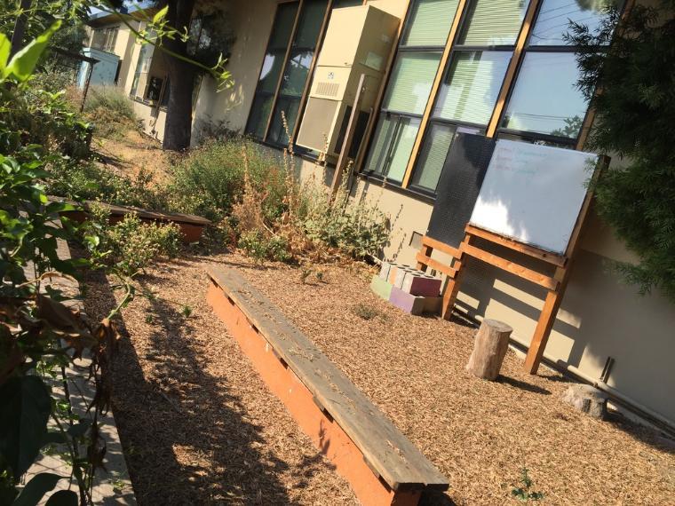 Whiteboard and benches at Gardner garden