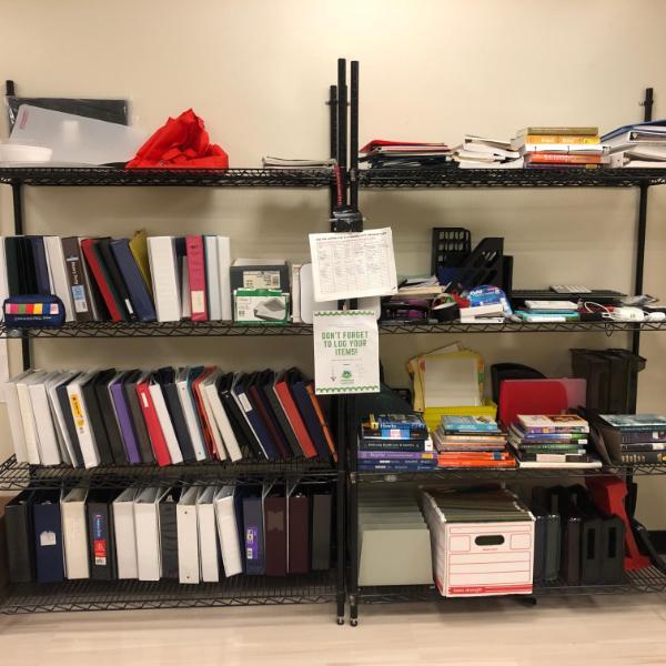 Shelves stacked with binders, notebooks, and textbooks