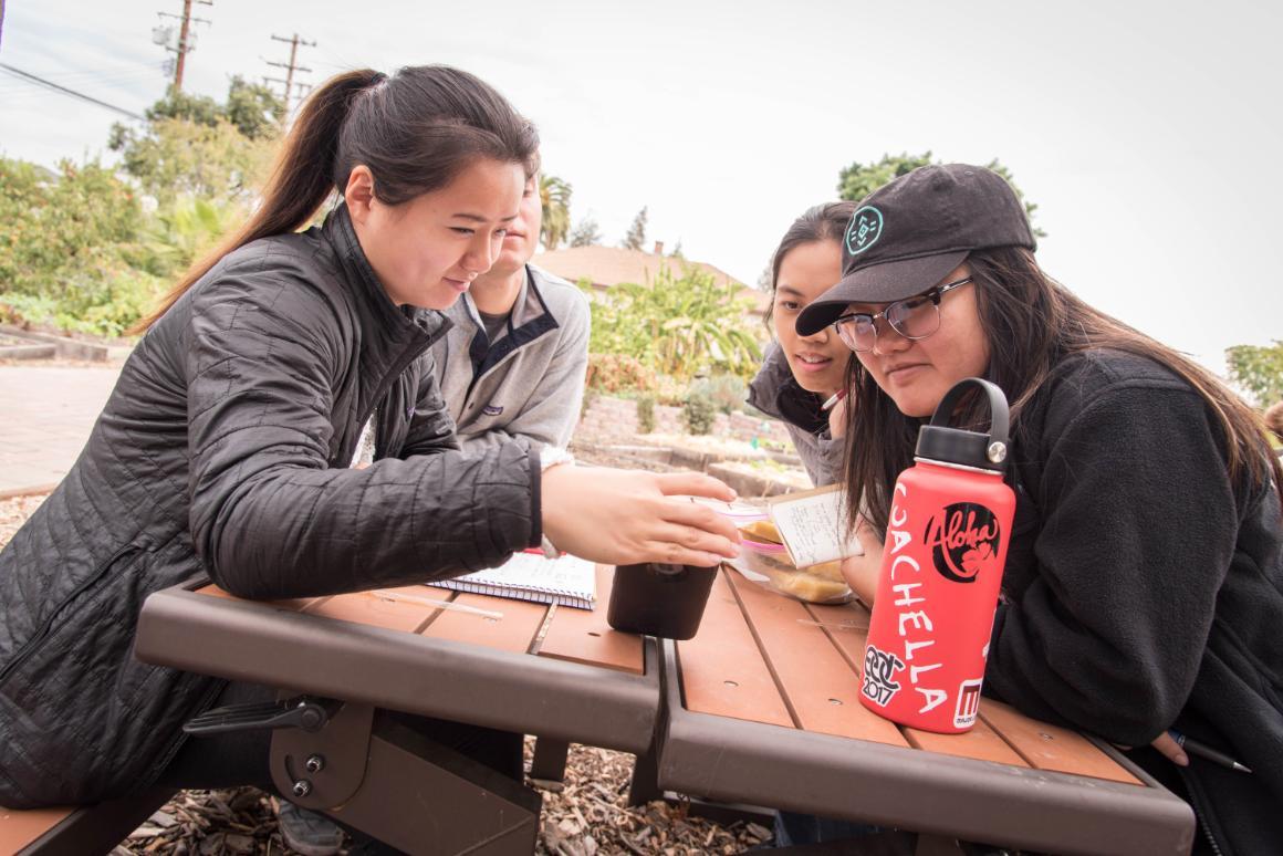 SCU students reading newsletter