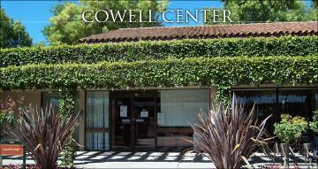 The Cowell Center entrance, covered with greenery and surrounded by plants.