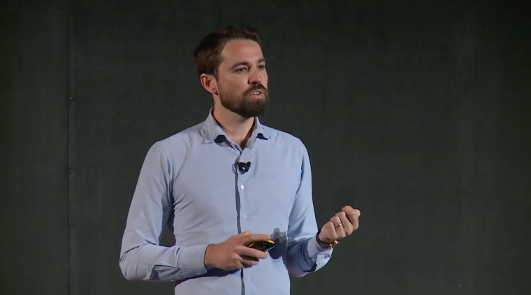 Former climate change policymaker and current student at London Business School Tiiram Sunderland speaks on stage during the TEDx London Business School conference.