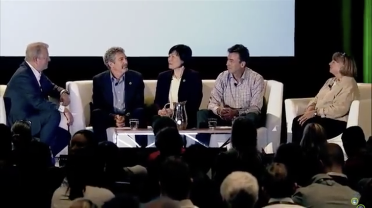 Four climate activists sit on stage with Al Gore on the left for a panel interview