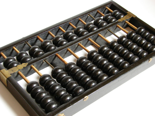 Alt text: Traditional wooden abacus with black and white beads.