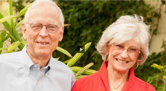 An elderly man and woman are smiling in an outdoor setting. image link to story