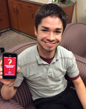 A person holding a smartphone displaying an app with a red screen. image link to story