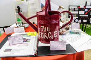 A red watering can with the text 