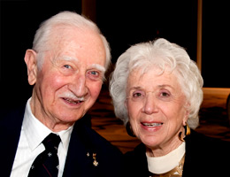 An elderly couple smiling and posing for a photo. image link to story