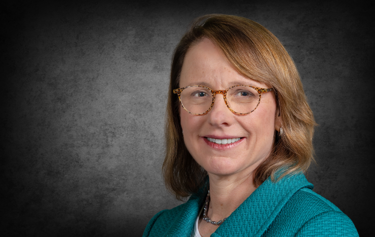 tightly cropped image of a woman in front of a dark gray background image link to story