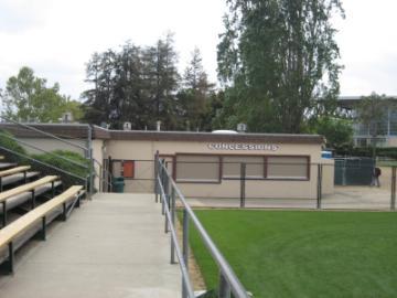 Alt text: Concession stand at Stevens Stadium with surrounding greenery and bleachers in the foreground.