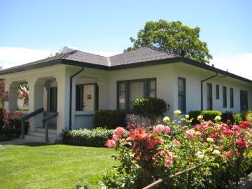 A small building with a garden in front.