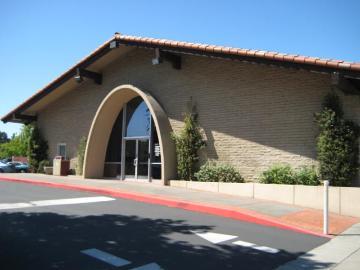 A beige building with an arched entrance at '990 Benton'.