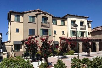 Three-story residential building with balconies and landscaping, labeled 'University Villas'.