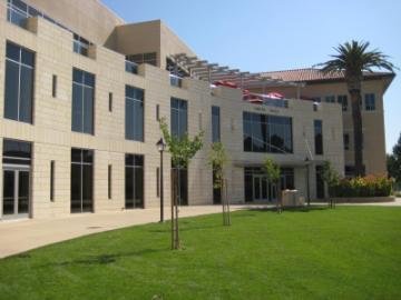 A photo of Lucas Hall North building with a lawn and trees.