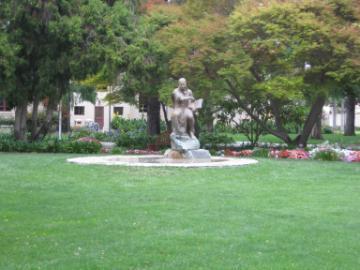 A fountain surrounded by trees and green lawn at St. Ignation Gardens.