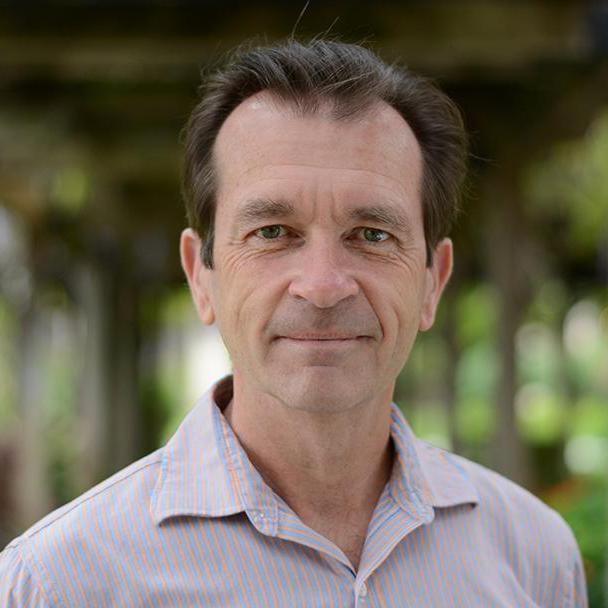 Close up of Thomas Plante in front of the Santa Clara University wisteria in the Mission Gardens