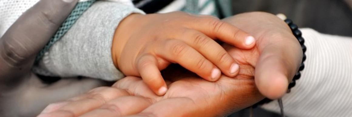 Several hands stacked together, showing unity and support.