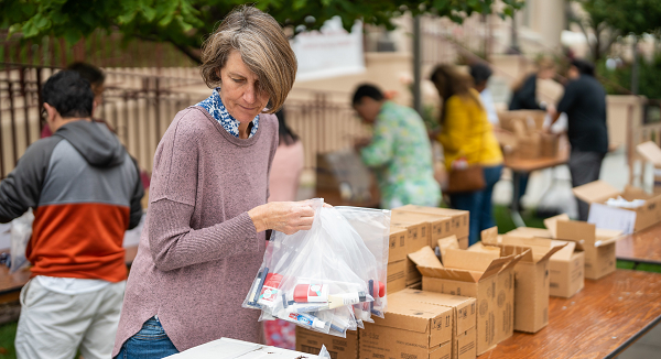 Woman assembling hygiene kits.