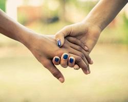 Two people holding hands.