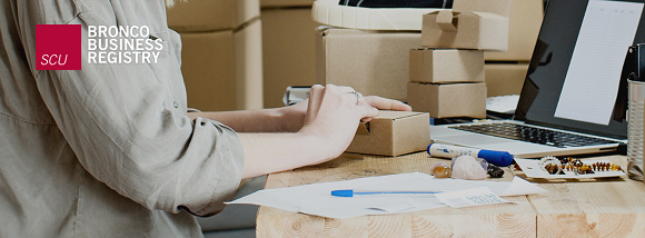 Woman packing a small box.