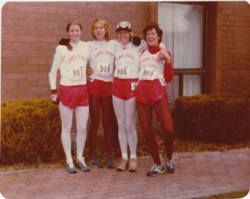 A group of five people in athletic outfits.