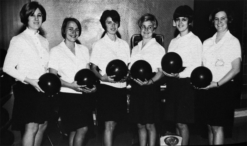 Six women holding bowling balls, posing as a 1968 women's bowling team.