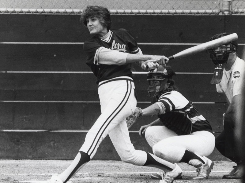 Two softball players, a batter and a catcher, in action from 1986 game.