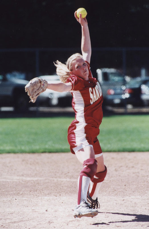 Softball pitcher mid-pitch on a softball field, 1998.