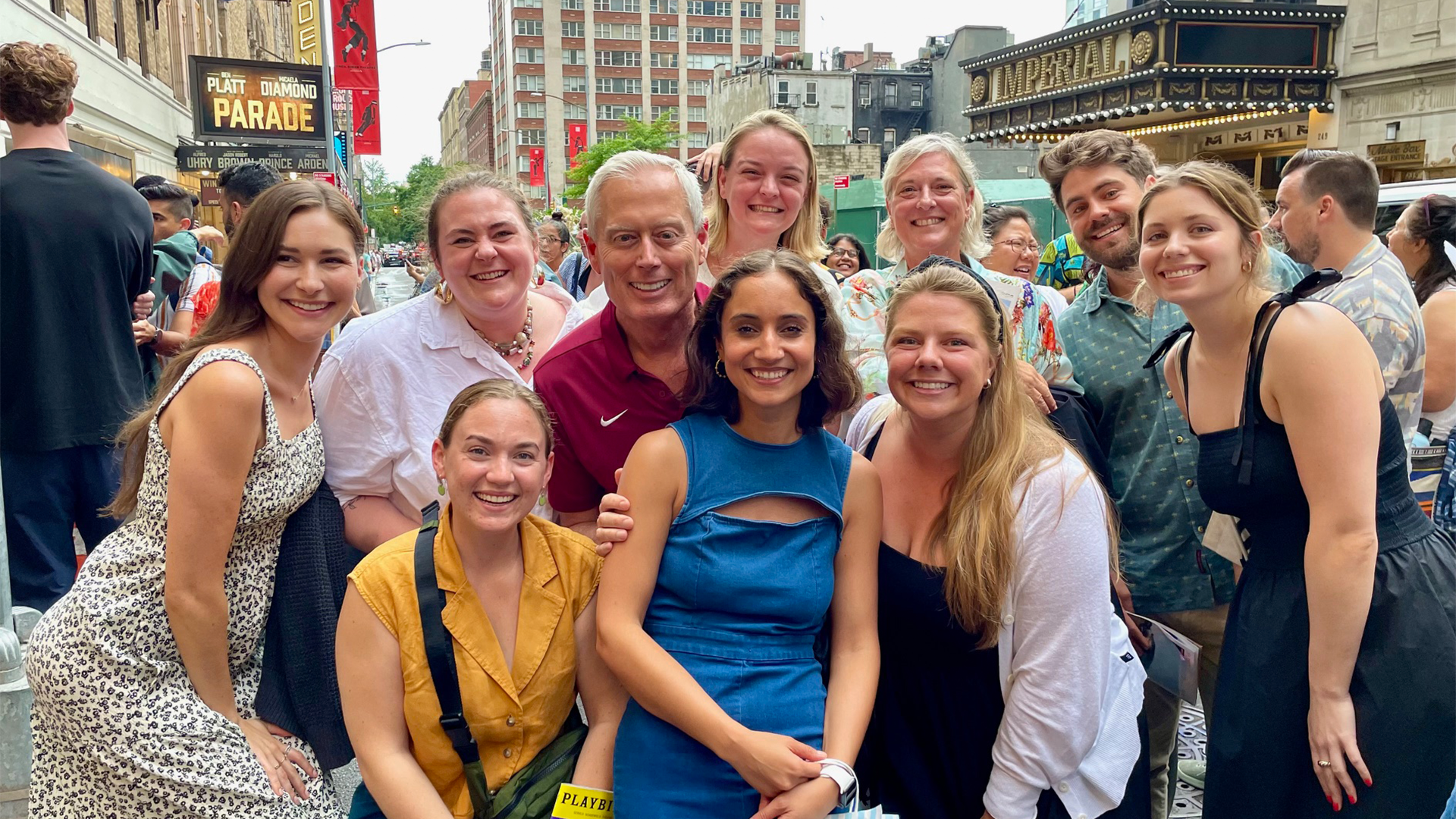 Group of alumni posing for photo on Broadway