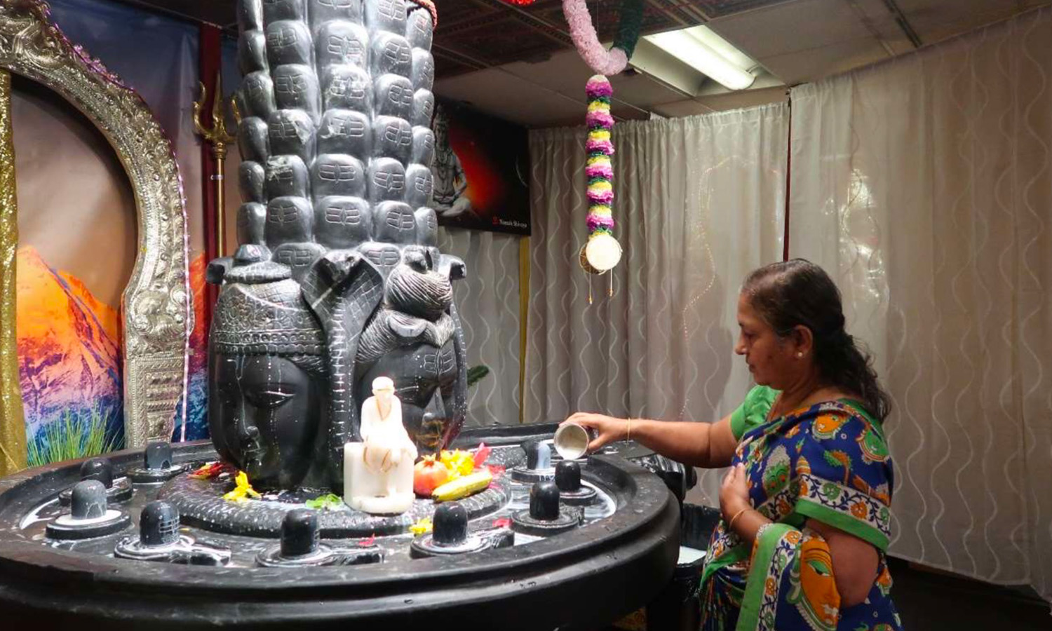 A woman examining artifacts in a museum display.