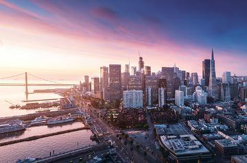 Aerial view of San Francisco with part of the Golden Gate Bridge in the background. 