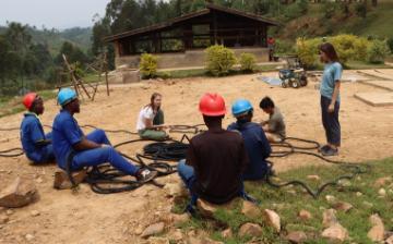 Group discussion in an outdoor rural setting with Engineers Without Borders team.