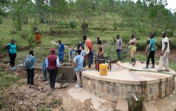 A group of people working around a circular structure outdoors.