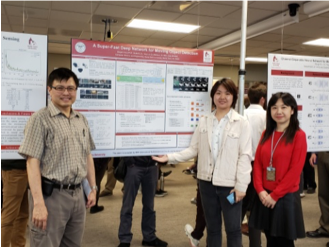 Three people standing in front of research posters at a presentation.