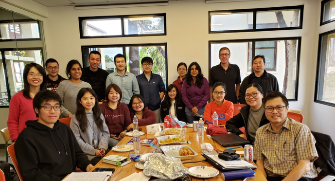 A group of people gathered around a table during a meeting.