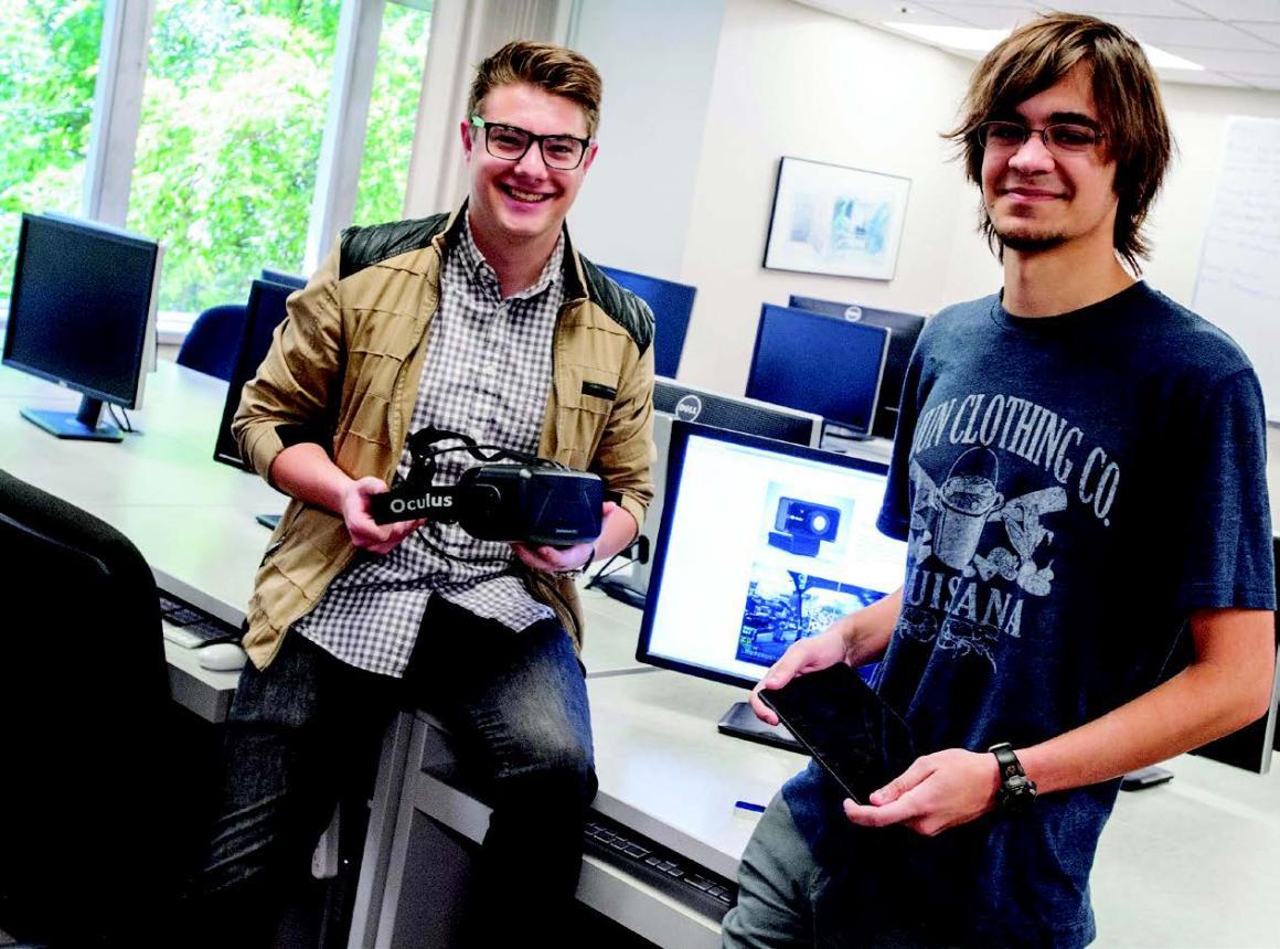 Bryce Mariano, left, and Paul Thurston show off the Oculus Rift and tablet that therapists employing their software can use to allay patients' fears.