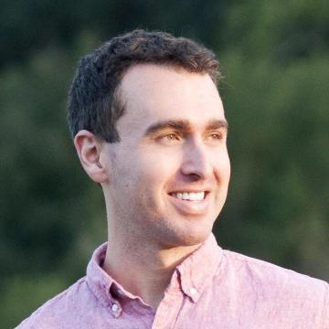 A person in a pink shirt outdoors, titled 'Alex Austin'.