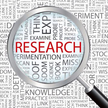 Magnifying glass focusing on the word Research