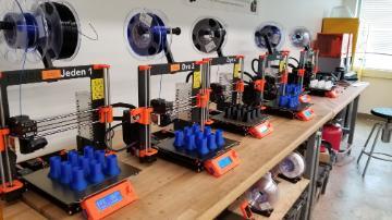 3D printers with test tube holders being printed