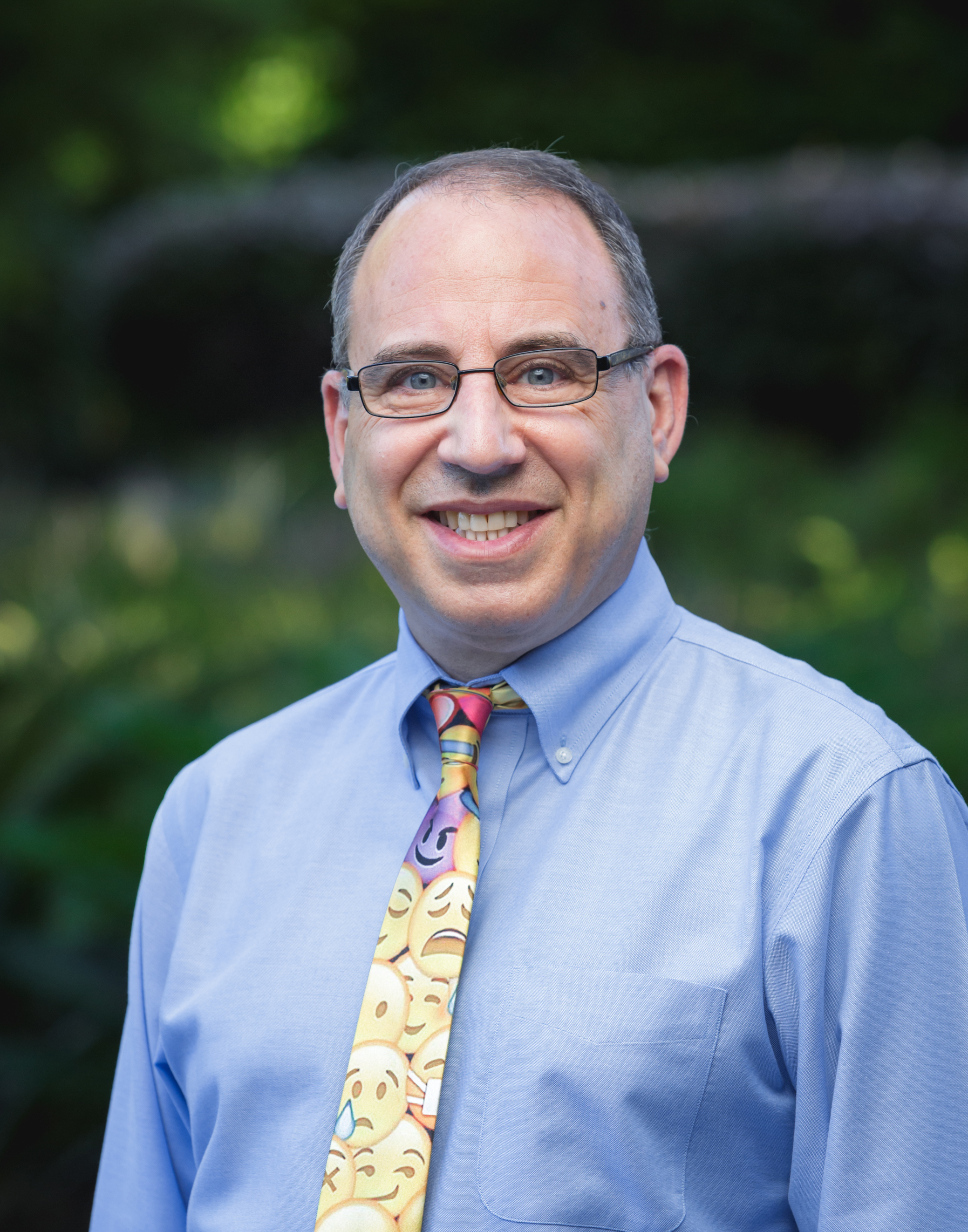 photo of Professor Eric Goldman a man wearing glasses a blue shirt and a yellow patterned tie