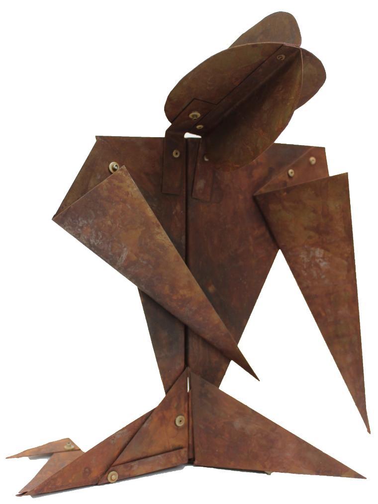 Abstract metallic sculpture with sharp, angular shapes forming a standing figure.