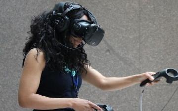 a woman using a virtual reality device.