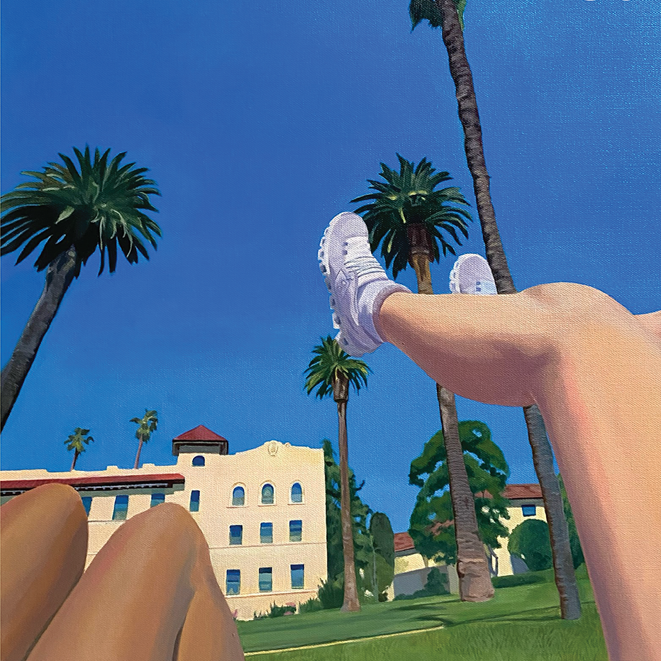 students reclined legs in a backdrop of adobe buildings, palm trees and clear blue sky