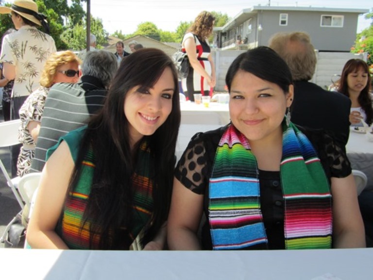 Two graduates at an outdoor brunch event in 2009.