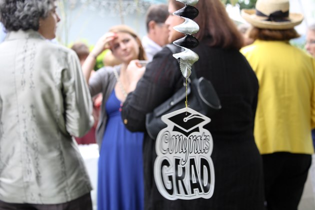 People gathered at a graduation brunch; a 