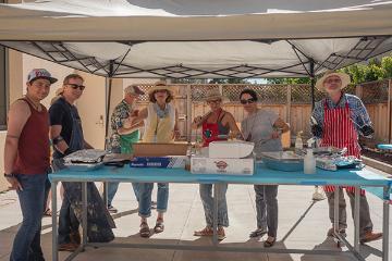 Faculty grilling food 